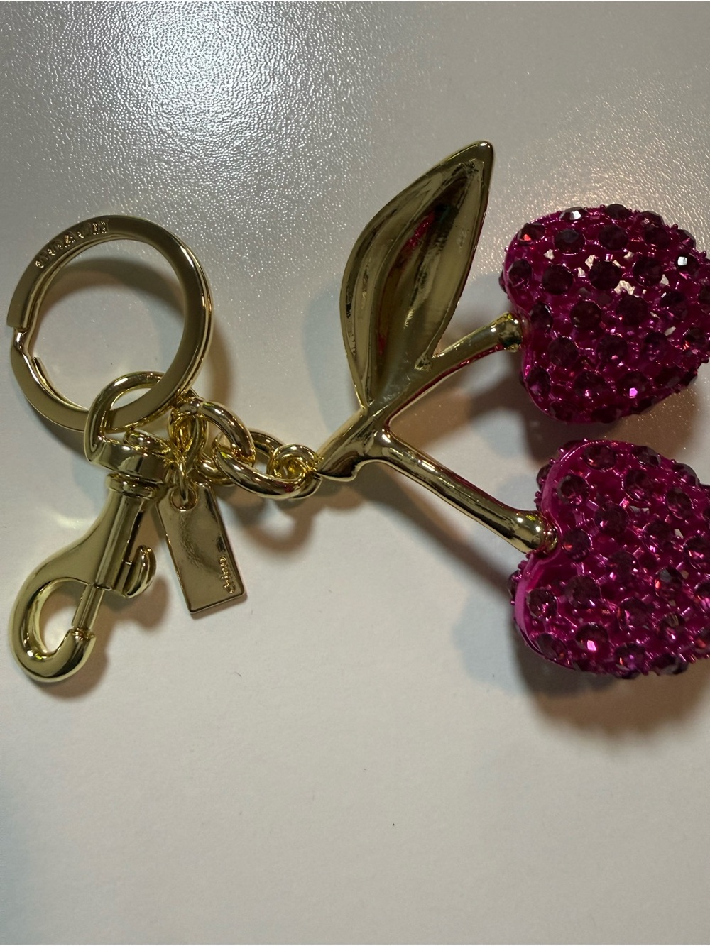 Coach Gold-Tone Double Cherry Key Charm with Pink Crystals